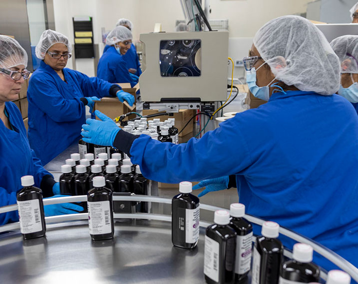scientists/pharmacists sorting medicine bottles